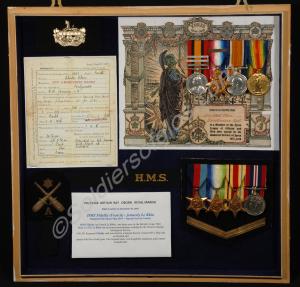 Framed medals with documents and badges for Oborn