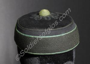 Pillbox cap with bright green piping. Worn by Lieu