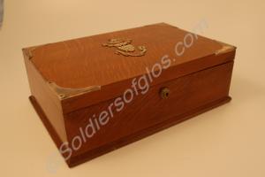 Wooden cigar box bound in brass with the badge of