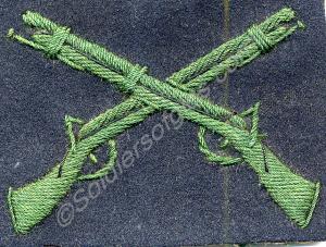 Marksman's badge, with green crossed rifles.  1st