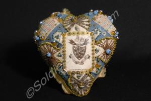 Pin cushion with regimental badge and texts. "When