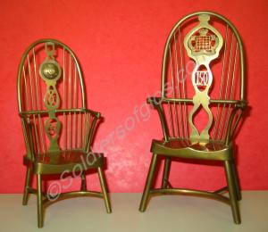 Two model brass Windsor chairs. Label underneath t