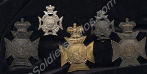 Five helmet plates worn by the 1st Gloucestershire