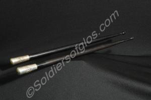 Pair of black wooden drum sticks shod with silver