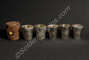 Five spirit beakers in a leather case. Each beaker