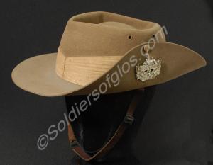 Khaki bush hat with white metal front badge, bronz