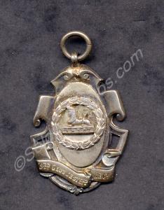 Silver Cricket Medal with the inscription "Company