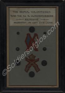 Framed and mounted collection of buttons and signa