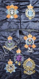 Three embroidered silk squares, one of the Glouces