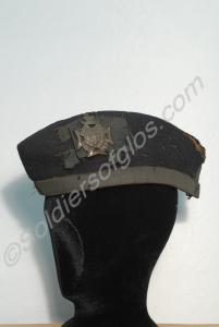 Glengarry cap with green pom-pom on the crown. Wor