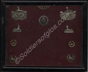 Case of  twelve badges. Four front badges, two bac