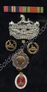 Five badges; bronze 1957 Application Badge, two br