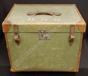 Green canvas trunk with brown leather fittings, wi