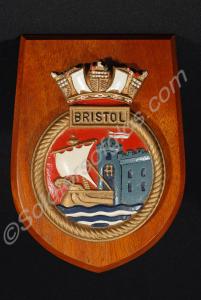 Small wooden shield-shaped plaque with a plaster b