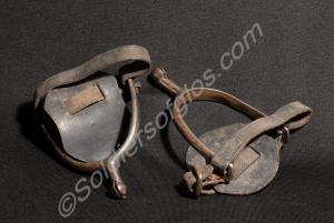 One pair of steel spurs with leather straps. F. Eg