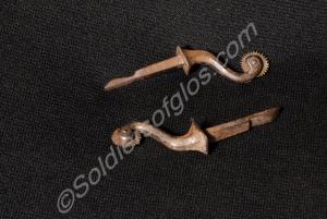 One rusted pair of small steel spurs- shaft and wh