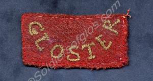 Red worsted oblong shoulder title, worn on the bac