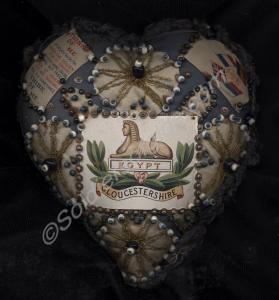 Blue and white pin cushion decorated with paper Gl