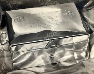 Framed picture of a silver casket presented to the
