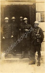 Group of soldiers wearing steel helmets outside a