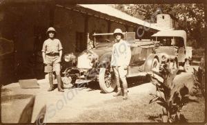 Two soldiers in tropical dress with cars.  5172829