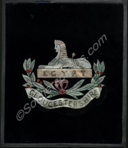 Gloucestershire Regiment insignia badge on glass.