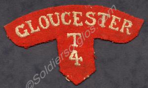 Shoulder titles in red worsted with white letters.
