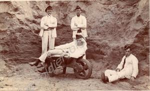 Four soldiers in fatigues with wheelbarrow. c. 191