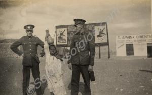 Two soldiers with local boy. 1st Battalion, The Gl