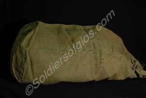 Light green canvas kit bag with some small holes o