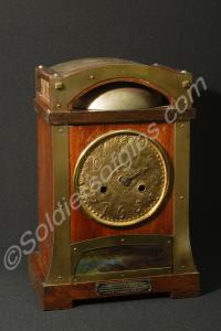 Chiming clock with a brass face in a home-made woo