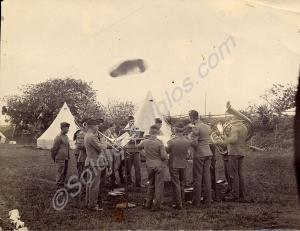 Band practice in a field. c. 1908. The Gloucesters
