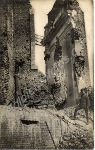 Soldier standing on the ruins of a church. 1/4th B