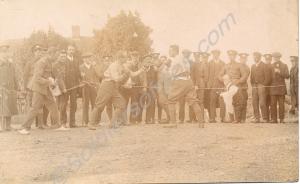 A boxing match. Reverse reads "This is how F Coy a