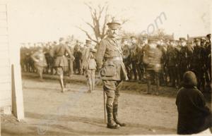 Field Officer standing in front of a parade.  Beli