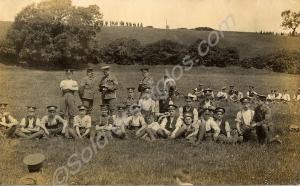 View of soldiers seated in field. (Probably 4th (T