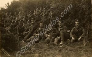 Group of soldiers seated in hedgreow, Swanage Camp