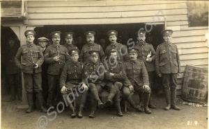 Group of soldiers outside weatherboarded building.