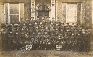 Group of soldiers with drums outside building . Un