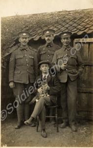 Three soldiers, young man and a kitten. Probably 1