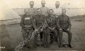 Group of sergeants outside a tent one wearing a pl