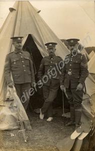 Group of three sergeants outside a tent one with m