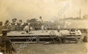 A boxing contest in an open air ring, presumed to