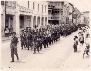Black and white photograph of troops marching thro