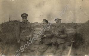 Three soldiers having a meal in a trench.  1/4th B
