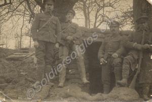 Four soldiers standing by a dugout.  1/4th Battali