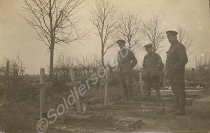 Three soldiers standing in a cemetery. 1/4th Batta