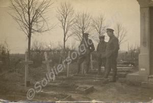 Three soldiers standing in a cemetery. 1/4th Batta