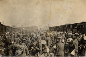 Soldiers crowded at a railway station. 1/4th Batta