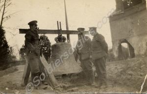 Three soldiers standing beside a dismantled church